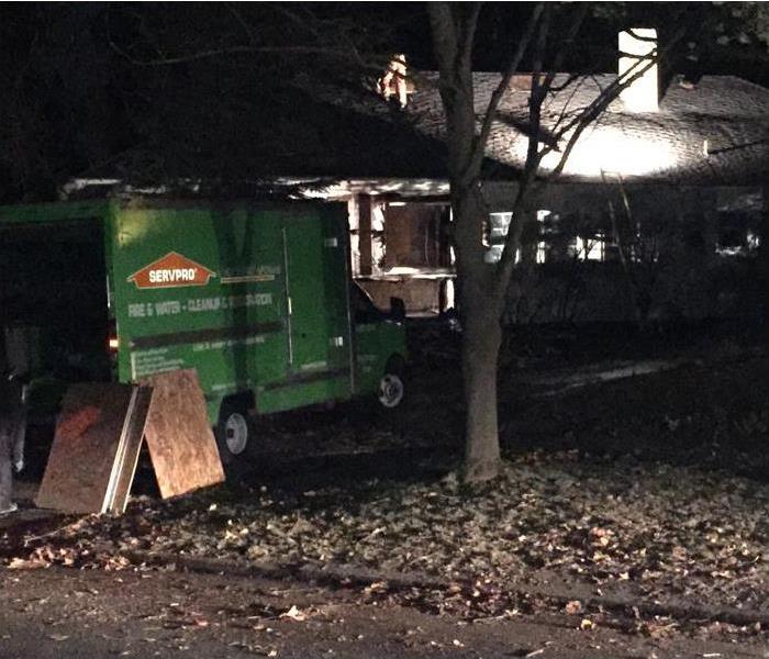 SERVPRO Specialists working at night to board up a damaged home.