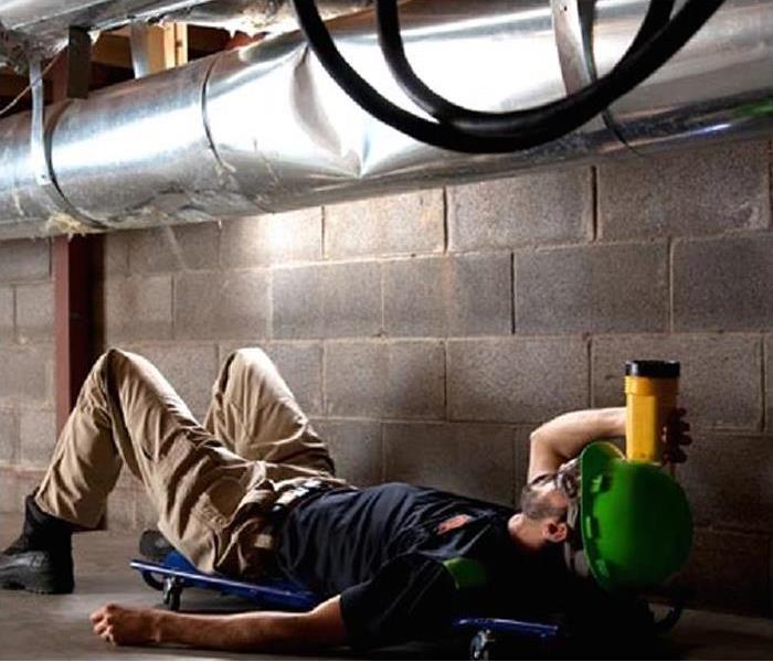 SERVPRO employee inspecting commercial HVAC system